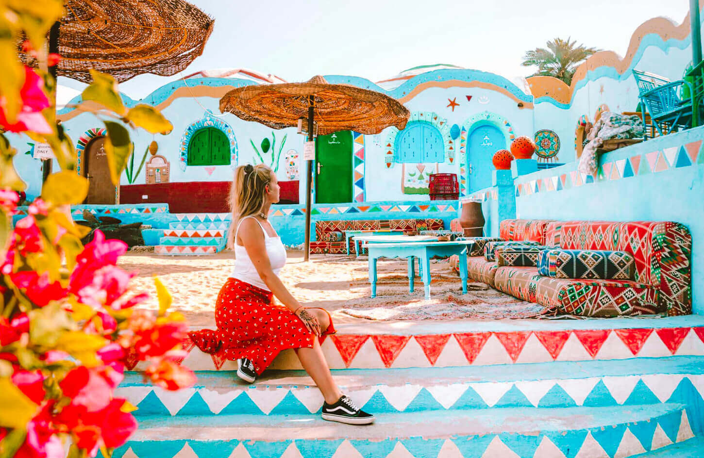 A-tourist-enjoys-sitting-in-the-Nubian-village Trip to The Nubian Villages By Boat