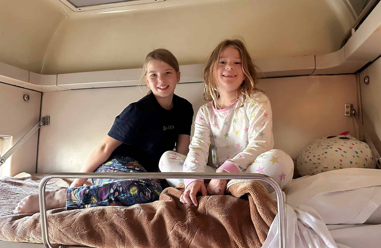 A boy and a girl enjoying a sleeper train in Egypt sleeper train in Egypt